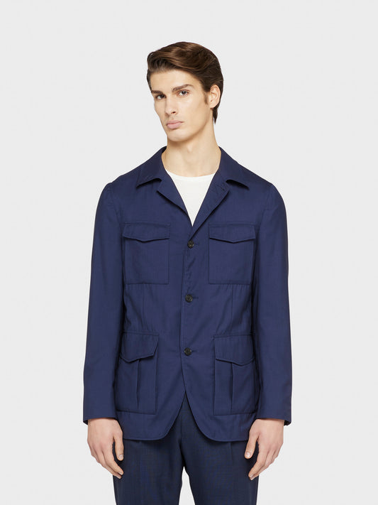 Caruso Menswear Abbigliamento Uomo Giacca Sahariana sfoderata estiva con quattro tasche a toppa di lana seta blu Nuage drop 8R indossato